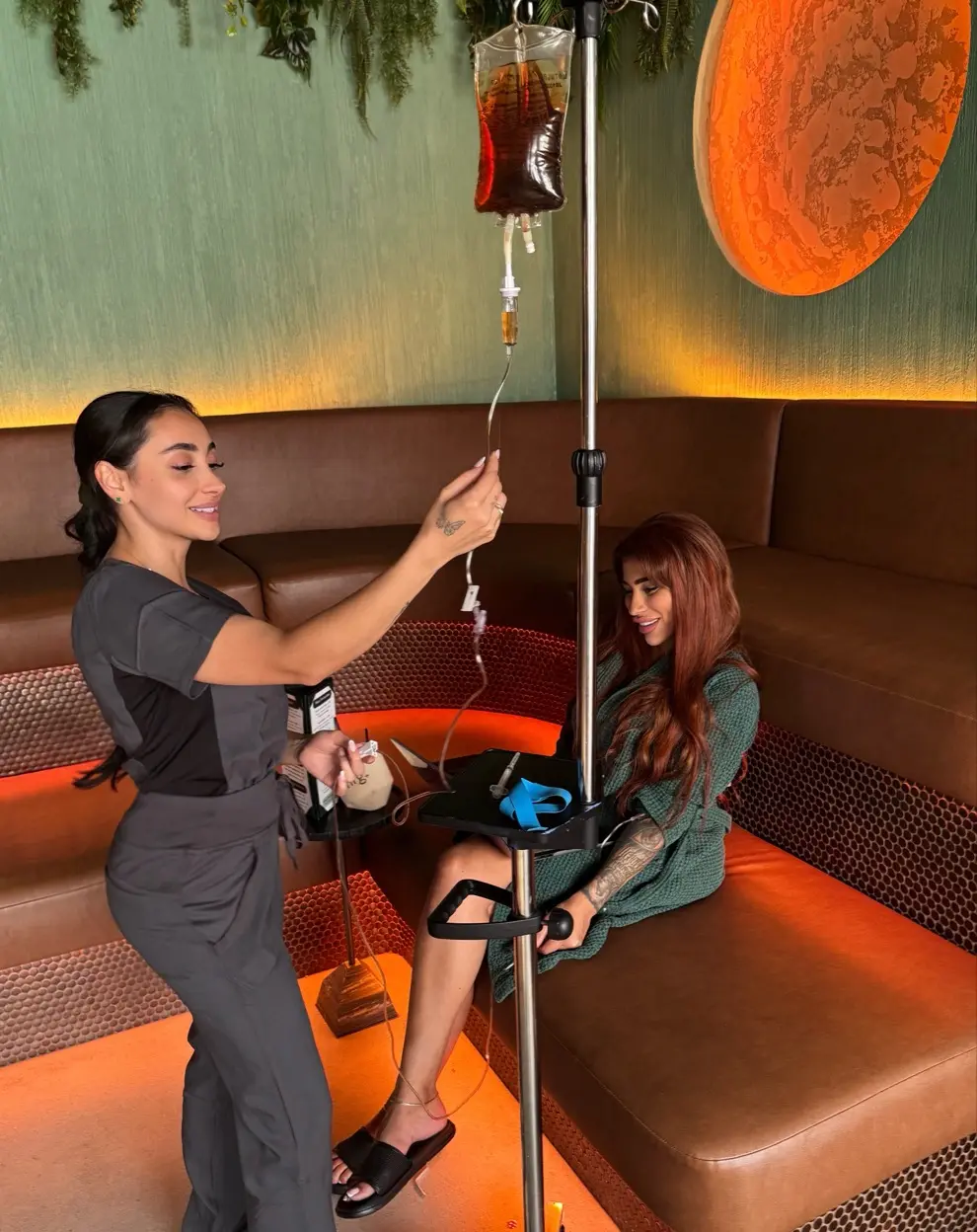 Kimia preparing an IV therapy infusion for a client